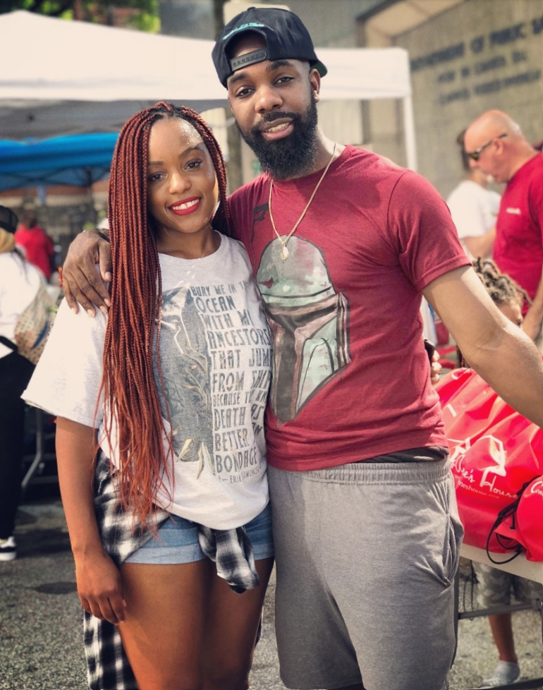 A Jo-Anne's House volunteer posing with a community member at the outreach
