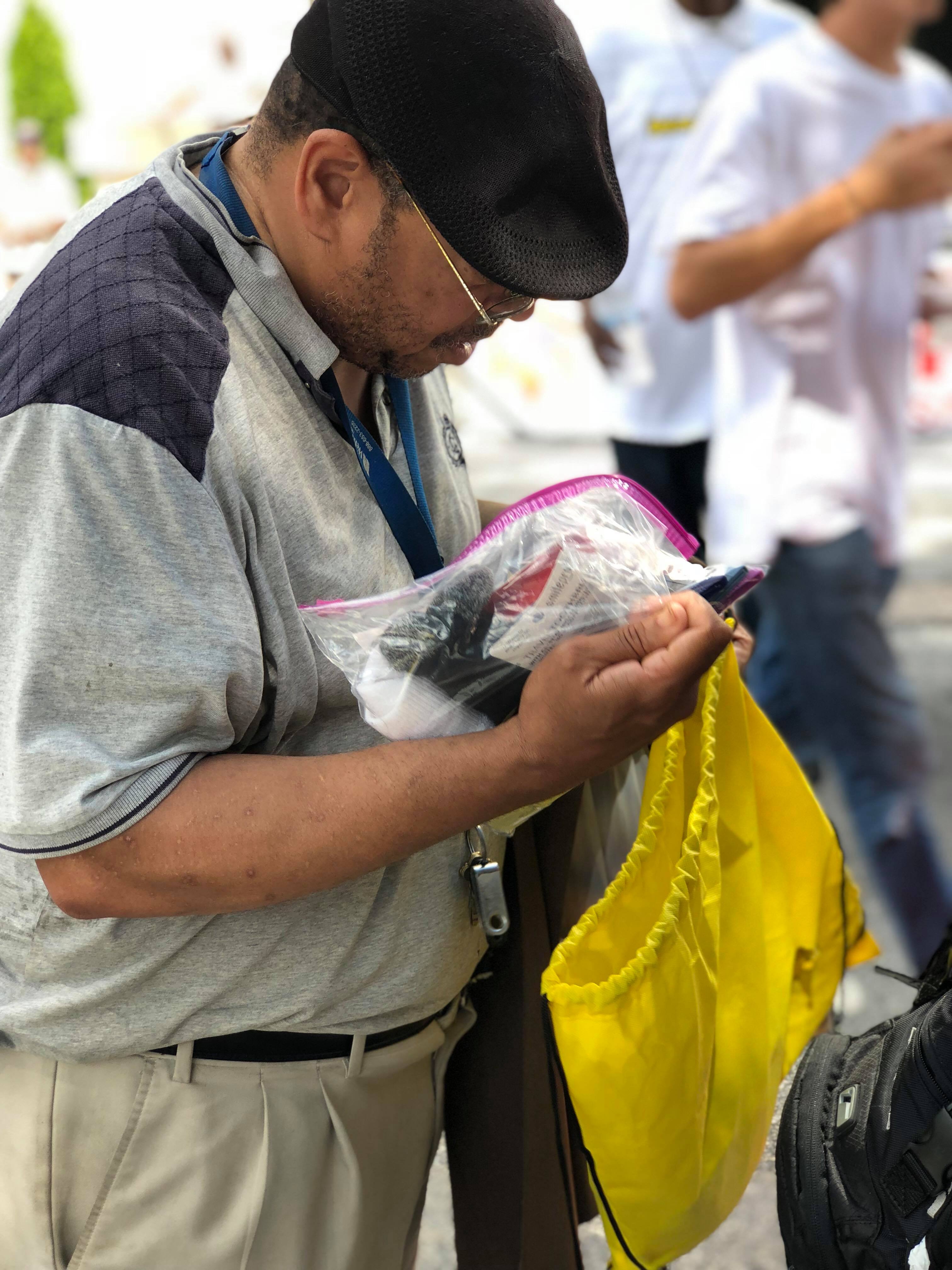 A man looking through the contents of his Jo-Anne's House care bag
