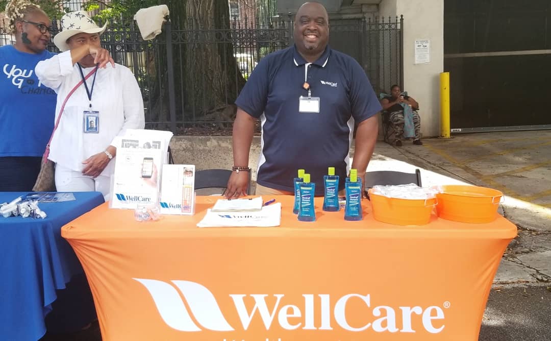 Volunteers handing out care bags at the outreach event