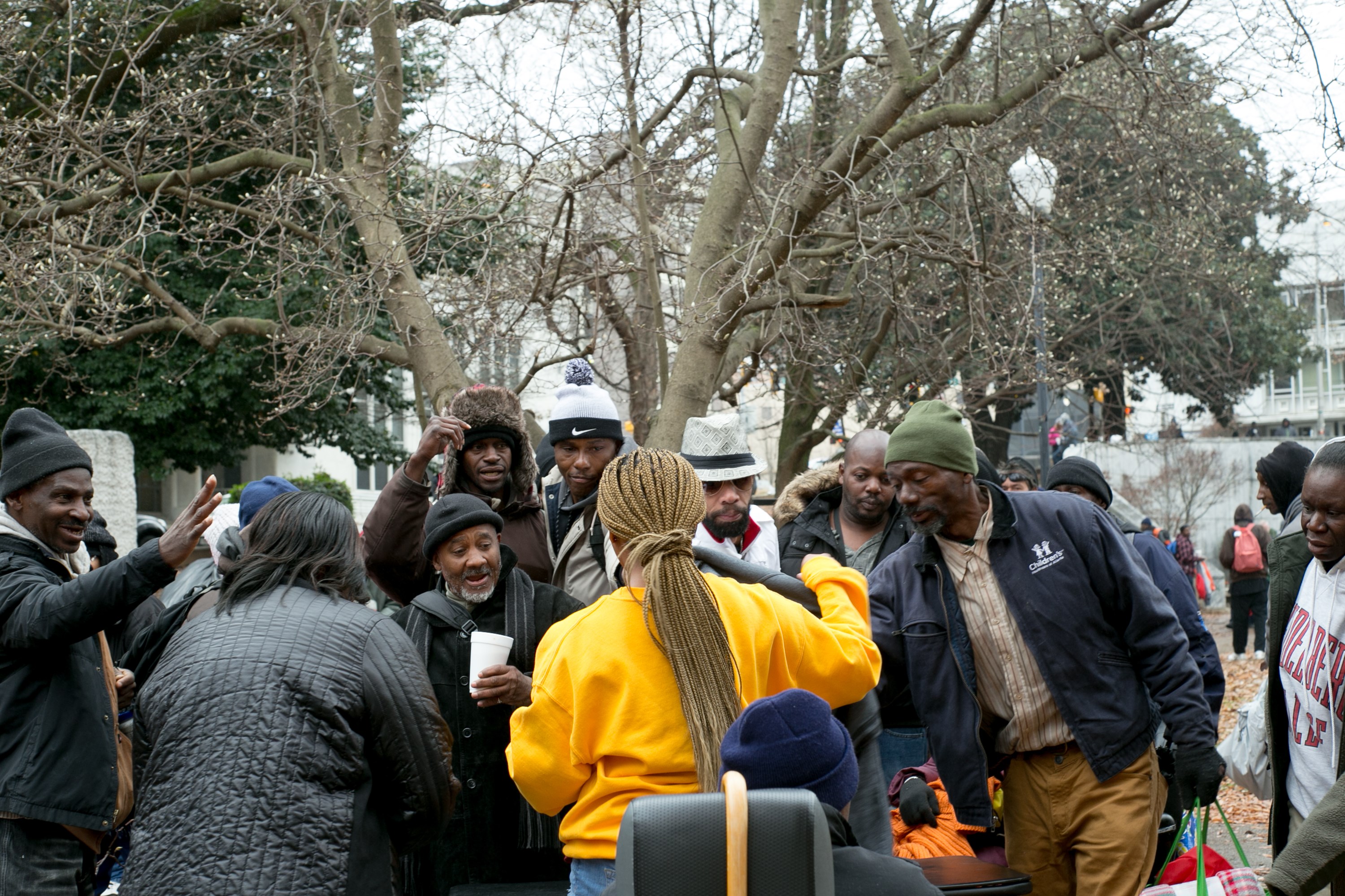 A crowd of volunteers and community members gathered together at the outreach