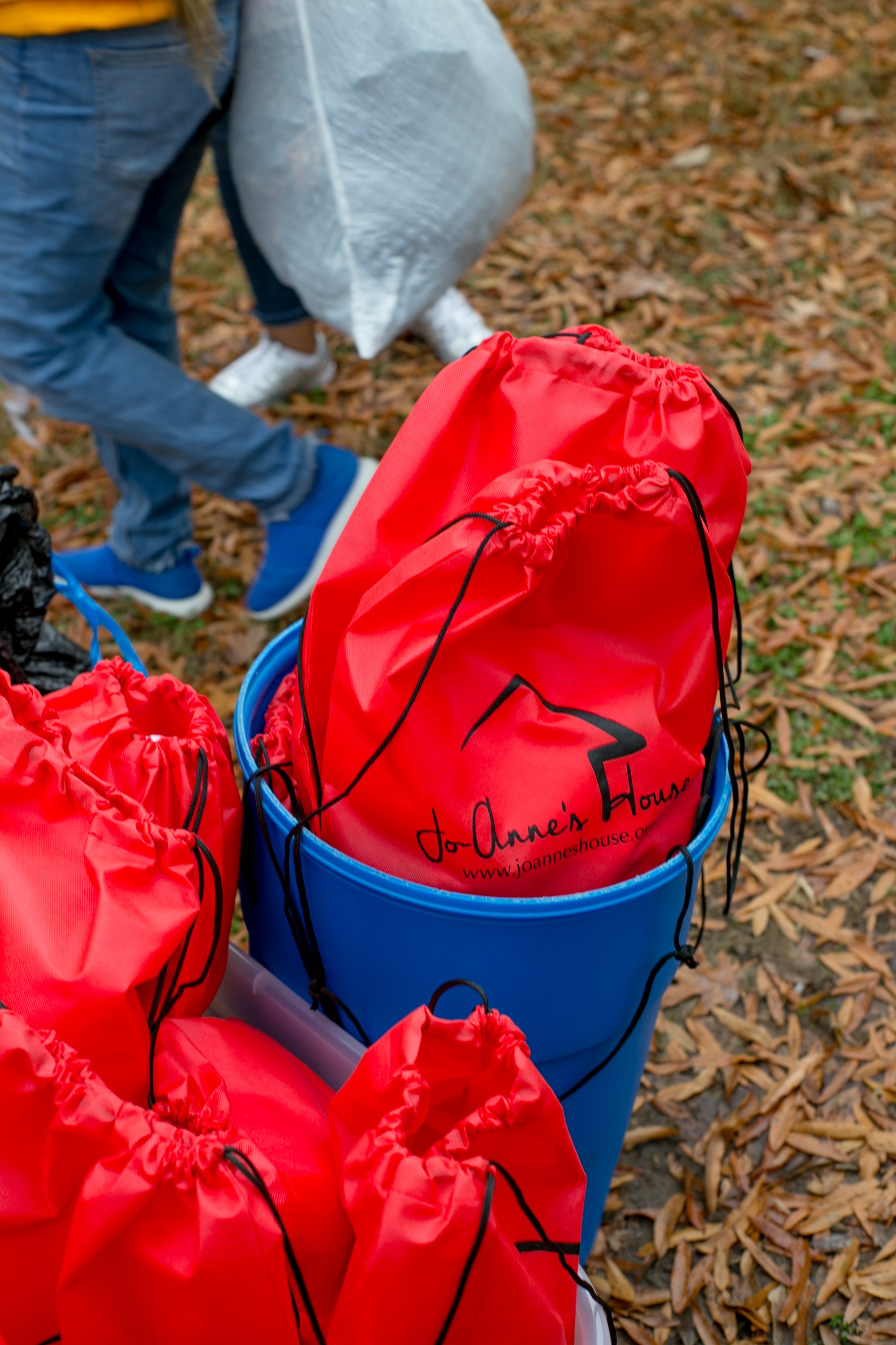 Red Jo-Anne's House care bags packed into a blue bucket ready for distribution