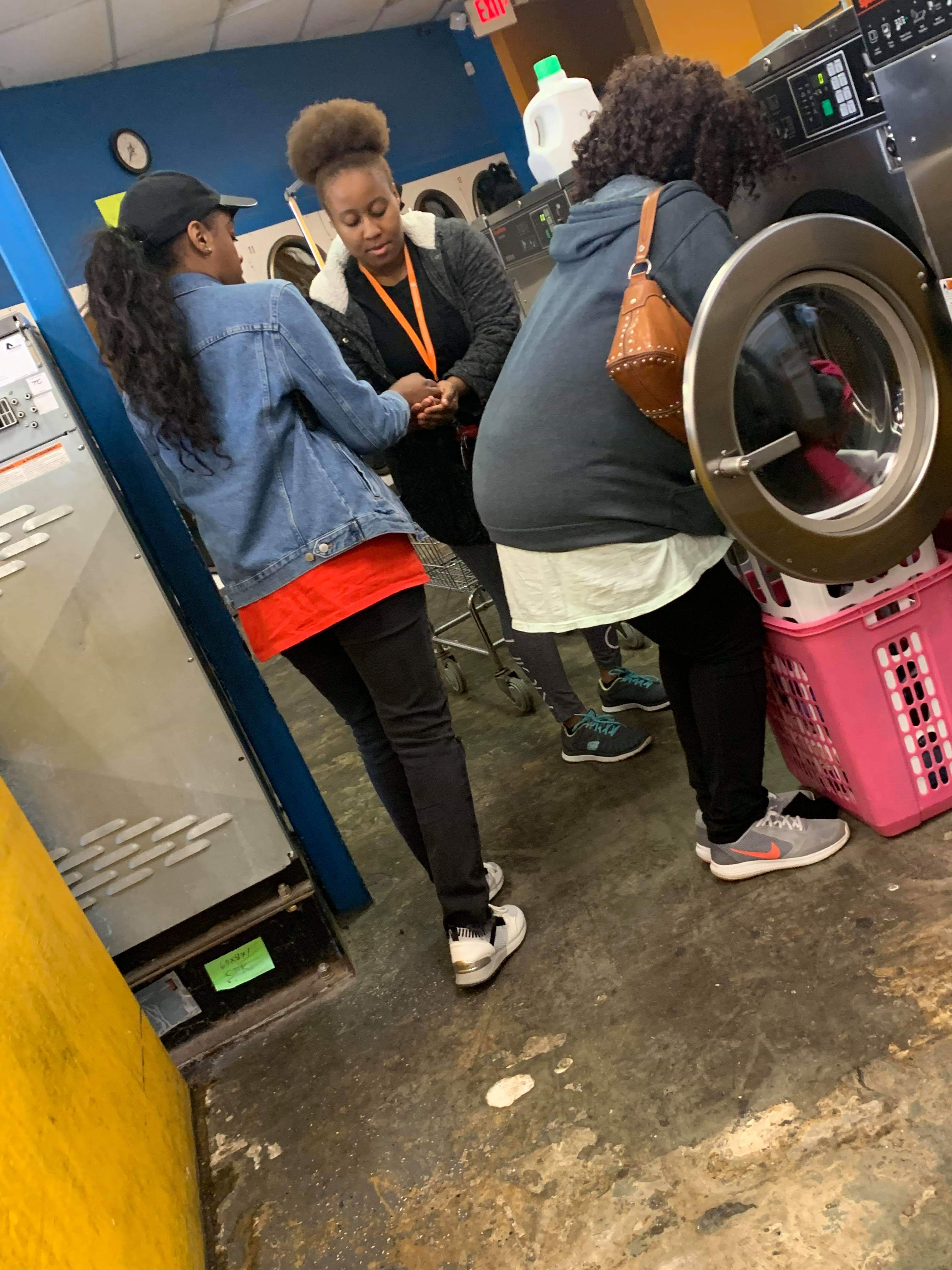 Families loading laundry into the washers during the outreach