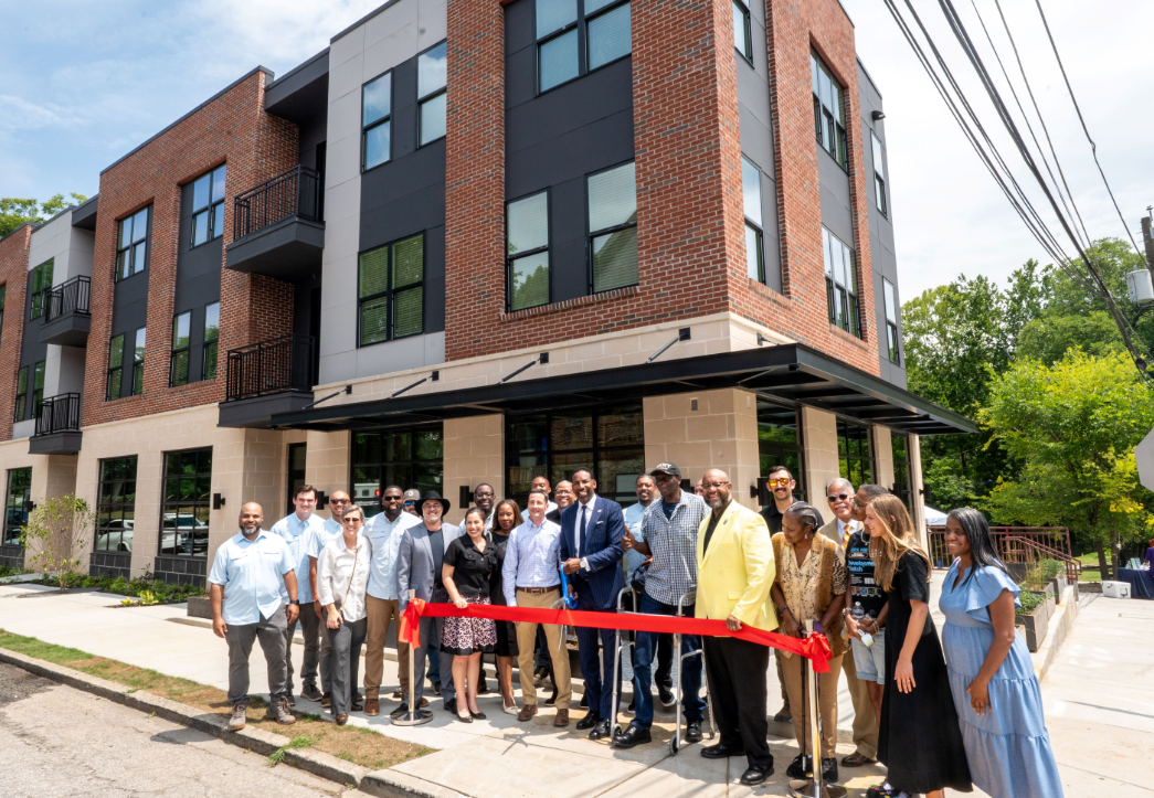 A ribbon cutting in front of the new Lindsay Street mixed-use building in English Avenue