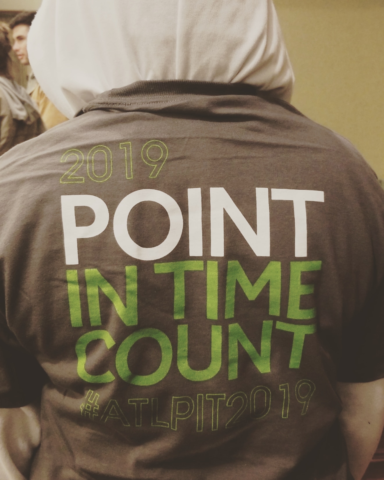 A volunteer wearing a 2019 Point-in-Time Count #ATLPIT2019 t-shirt