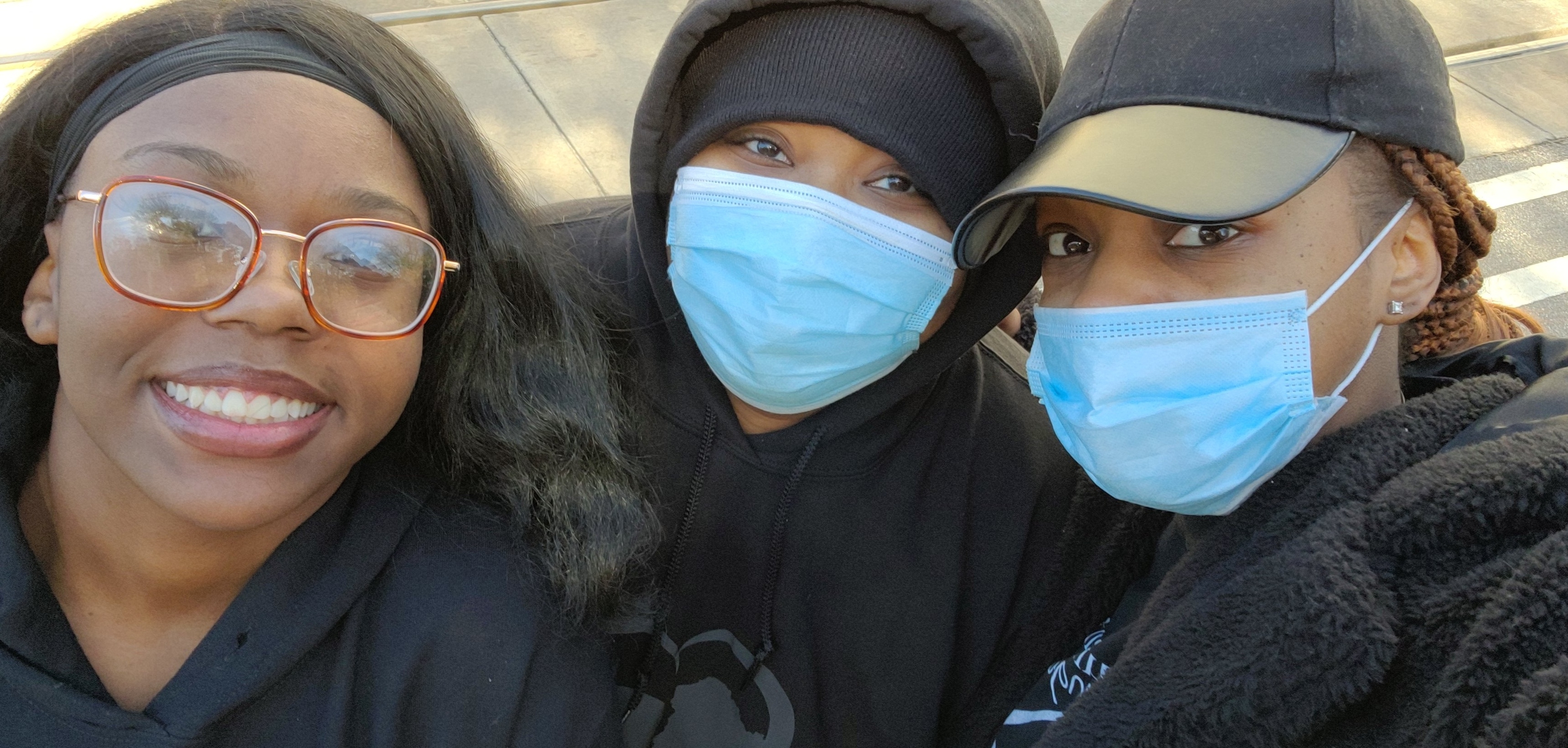 A close-up selfie of three masked Jo-Anne's House volunteers during the Thanksgiving outreach